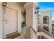 Front door entrance of condo featuring a welcome mat, light fixture, and stucco pillar at 9151 W Greenway Rd # 258, Peoria, AZ 85381