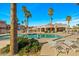 Community pool area with lounge chairs and lush landscaping, perfect for relaxation and enjoying the sunny weather at 9151 W Greenway Rd # 258, Peoria, AZ 85381