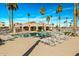 Community pool surrounded by palm trees and lounge chairs for relaxation and enjoying the sunny weather at 9151 W Greenway Rd # 258, Peoria, AZ 85381