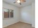 Well-lit bedroom with a ceiling fan, neutral carpet, and a large shuttered window at 9214 N 83Rd St, Scottsdale, AZ 85258