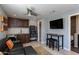 Cozy living room features dark cabinets, a kitchenette, modern appliances, and a mounted TV at 9214 N 83Rd St, Scottsdale, AZ 85258