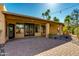 Covered patio with rock features, pavers, and desert landscaping, perfect for enjoying the outdoors at 9214 N 83Rd St, Scottsdale, AZ 85258