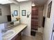 Bathroom with beige countertop, white sink, large mirror, and shower with striped curtain at 925 E Lancaster Cir, Florence, AZ 85132