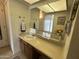 Bathroom showcasing a vanity with a white sink, large mirror, neutral walls and a small shelf at 925 E Lancaster Cir, Florence, AZ 85132