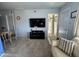 Comfortable living room featuring a mounted TV, neutral walls, and an open doorway at 925 E Lancaster Cir, Florence, AZ 85132