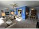 Cozy living room with plush seating, carpeted floors, and a view into the adjacent kitchen at 925 E Lancaster Cir, Florence, AZ 85132