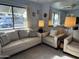 Bright living room with plush sofas and a large window providing natural light and street views at 925 E Lancaster Cir, Florence, AZ 85132