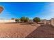 Spacious backyard featuring low-maintenance gravel landscaping and mature, round trees for shade and appeal at 9283 W Rafael Dr, Arizona City, AZ 85123