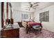 Cozy bedroom featuring a four-poster bed, dresser, and soft carpet at 9283 W Rafael Dr, Arizona City, AZ 85123