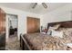 Bedroom featuring a ceiling fan, closet, and a comfortable bed with decorative pillows at 9283 W Rafael Dr, Arizona City, AZ 85123