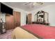 Bedroom featuring a bed, dresser, closet, and wall-mounted TV at 9283 W Rafael Dr, Arizona City, AZ 85123