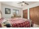 Bedroom featuring a ceiling fan, dresser, and a comfortable bed with a patterned blanket at 9283 W Rafael Dr, Arizona City, AZ 85123