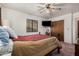 Bedroom featuring a bed, closet, television, and a ceiling fan at 9283 W Rafael Dr, Arizona City, AZ 85123