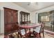 Traditional dining room with wood cabinets, a large table, and sliding glass doors at 9283 W Rafael Dr, Arizona City, AZ 85123