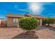 Single level home showcasing desert landscaping, a two car garage, and a front entrance with gate at 9283 W Rafael Dr, Arizona City, AZ 85123