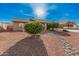 Single level home showcasing desert landscaping, a two car garage, and a front entrance with gate at 9283 W Rafael Dr, Arizona City, AZ 85123