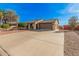 Expansive driveway leading to a single level home with desert landscaping and a two car garage at 9283 W Rafael Dr, Arizona City, AZ 85123