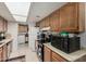 Functional kitchen with light wood cabinetry, white tile, and standard appliances at 9283 W Rafael Dr, Arizona City, AZ 85123