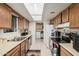 Bright kitchen with wood cabinets, white appliances, and tile flooring at 9283 W Rafael Dr, Arizona City, AZ 85123