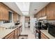 Well-lit kitchen featuring classic wooden cabinets and essential appliances at 9283 W Rafael Dr, Arizona City, AZ 85123