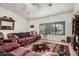 A spacious living room with tile flooring, a ceiling fan, and large window at 9283 W Rafael Dr, Arizona City, AZ 85123