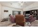 A spacious living room with tile flooring, a ceiling fan, and plentiful seating at 9283 W Rafael Dr, Arizona City, AZ 85123