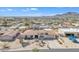 Aerial view of a charming desert home with a well-manicured yard, a pool, and beautiful mountain views at 9410 N 18Th St, Phoenix, AZ 85020