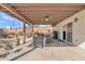 Comfortable covered back patio featuring stylish seating, a ceiling fan, a BBQ grill, and desert landscaping at 9410 N 18Th St, Phoenix, AZ 85020