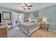 Serene bedroom with soft blue walls, a ceiling fan, and a window view offering natural light at 9410 N 18Th St, Phoenix, AZ 85020