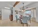 Charming dining area featuring a round table, upholstered chairs, and a backyard view with a sparkling pool at 9410 N 18Th St, Phoenix, AZ 85020