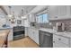 Well-lit kitchen featuring updated appliances, granite countertops, white cabinets and backyard views at 9410 N 18Th St, Phoenix, AZ 85020