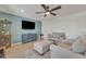 Cozy living room features a ceiling fan, tile floors, and a modern entertainment center at 9410 N 18Th St, Phoenix, AZ 85020