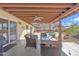 Inviting covered patio with wicker furniture, offering a great view of the pool, mountains, and desert landscape at 9410 N 18Th St, Phoenix, AZ 85020