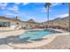 Refreshing in-ground swimming pool with desert landscaping, palm trees, mountain views, and poolside lounge chairs at 9410 N 18Th St, Phoenix, AZ 85020