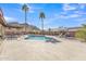 Inviting in-ground swimming pool with desert landscaping, a covered patio, poolside lounge chairs, and mountain views at 9410 N 18Th St, Phoenix, AZ 85020