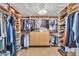 Spacious walk-in closet with custom shelving, drawers, and a chandelier, offering ample storage and organization at 9410 N 18Th St, Phoenix, AZ 85020