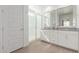 Bright bathroom featuring double vanity, framed mirrors, and a glass shower at 9610 E Trent Ave, Mesa, AZ 85212