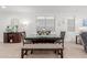 Cozy dining room with neutral walls, a dark wood table, bench seating, and modern decorations at 9610 E Trent Ave, Mesa, AZ 85212