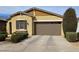 Charming single-story home featuring a tandem garage and desert landscaping, creating an inviting curb appeal at 9610 E Trent Ave, Mesa, AZ 85212