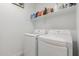 Well-equipped laundry room with full-size LG washer and dryer set under a shelf for optimal space and organization at 9610 E Trent Ave, Mesa, AZ 85212