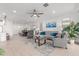 Open-concept living area flowing into dining with tile floors, comfortable seating, and natural light at 9610 E Trent Ave, Mesa, AZ 85212