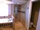 Modern bathroom with tiled shower, separate tub, and sleek fixtures at 10116 W Bolivar Dr, Sun City, AZ 85351