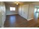 Bedroom with laminate flooring, dual closets, neutral paint, and a sunny window at 10116 W Bolivar Dr, Sun City, AZ 85351