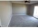 Bedroom with neutral carpet and sliding door to outside at 10116 W Bolivar Dr, Sun City, AZ 85351