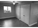 Spacious bedroom features a ceiling fan, wood-look floors, large closets, and a bright window view at 10116 W Bolivar Dr, Sun City, AZ 85351