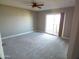 Bedroom features neutral carpet, natural light, and sliding door to patio at 10116 W Bolivar Dr, Sun City, AZ 85351