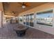 Enjoy this large covered patio featuring a cozy fireplace and views of the waterfront at 10116 W Bolivar Dr, Sun City, AZ 85351