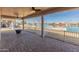 Spacious covered patio with brick flooring and stunning water views and boat dock at 10116 W Bolivar Dr, Sun City, AZ 85351