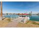 Pontoon boat moored at a private dock with waterfront views at 10116 W Bolivar Dr, Sun City, AZ 85351