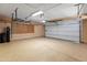 Well-lit garage with overhead storage and water treatment system at 10116 W Bolivar Dr, Sun City, AZ 85351